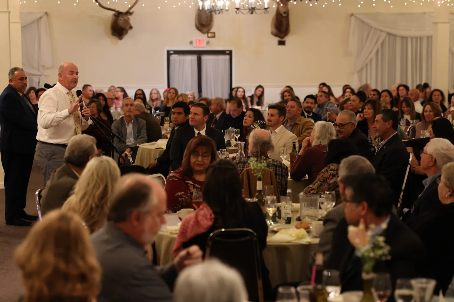 A large group of people sitting at tables.