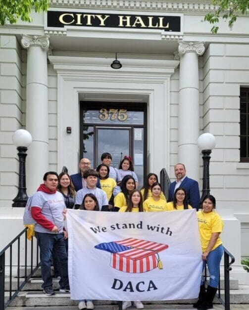 A group of people standing in front of a building.