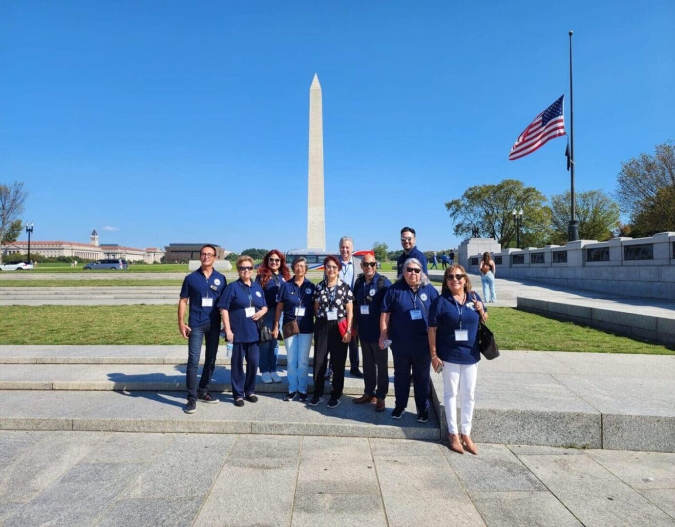 A group of people standing in front of the washington monument.