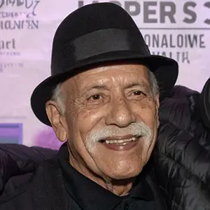 A man with a mustache wearing a hat.