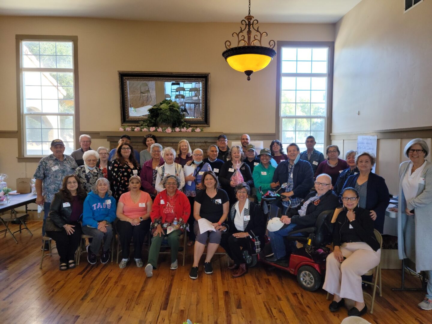 A group of people sitting in chairs and posing for a picture.