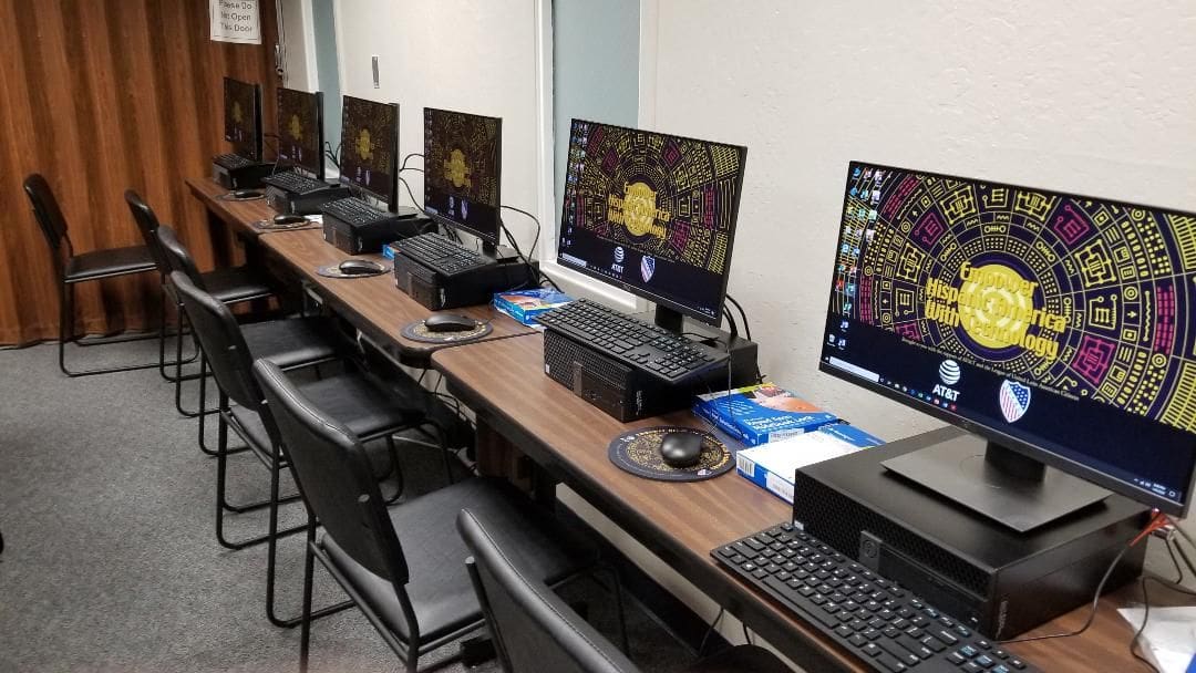 A long table with many computers on it